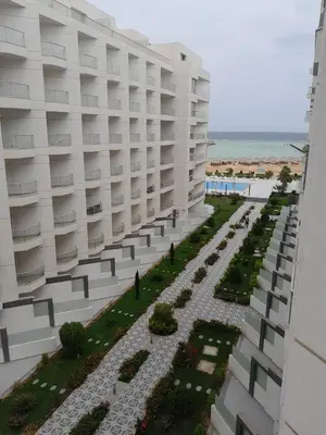 an external view of a building with a garden at شالية في كمباوند سكانديك عرابيا in Hurghada