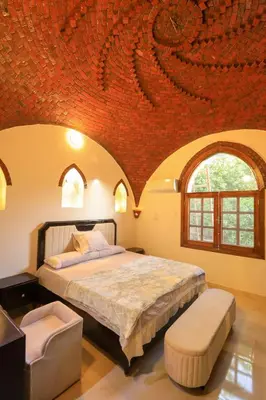 a bedroom with a bed with a red ceiling at Desert Rose apartments in Luxor
