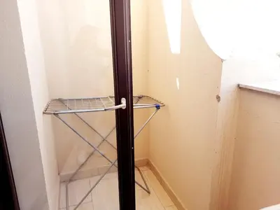 a small closet with a glass door and a shelf at Units for rent in Hurghada in Hurghada