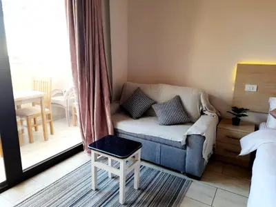 a living room with a couch and a window at Units for rent in Hurghada in Hurghada