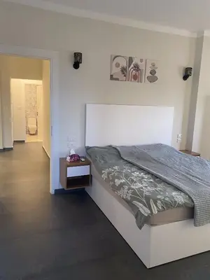 a bedroom with a large bed and a table at DiveZen Sea View apartment in Quseir