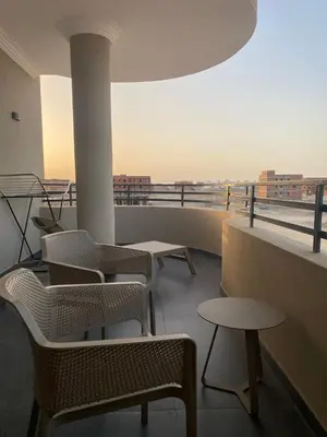 a group of chairs and tables on a balcony at DiveZen Sea View apartment in Quseir