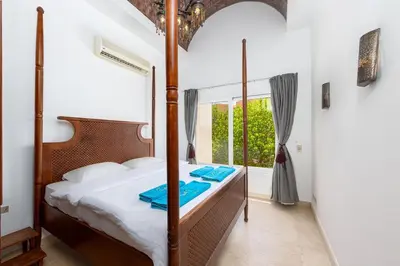 a bedroom with a four poster bed and a window at Townhouse South Marina in Hurghada