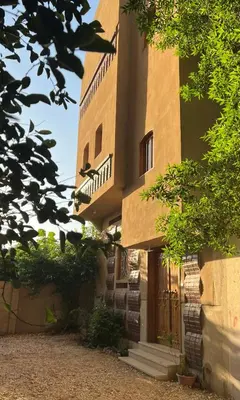 a building with a staircase on the side of it at Lady of the Sun Guesthouse in Luxor