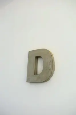 a metal object hanging on a white wall at One bedroom apartment with a hall in Aqua Infinity Resort before El Gouna in Hurghada