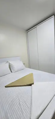 a white bed with a napkin on top of it at Tiba Golden Red Sea Coral Hurghada in Hurghada
