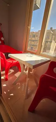 a table and chairs in a room with a window at Tiba Golden Sun-kissed Hurghada in Hurghada