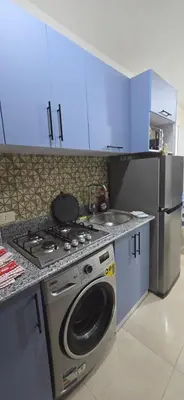 a kitchen with a stove and a sink at Tiba Golden Royal Blue Hurghada in Hurghada