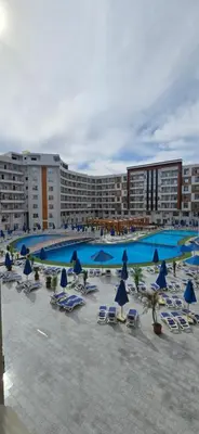 a resort with chairs and umbrellas and a pool at Tiba Golden Lagoon Hurghada in Hurghada