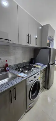 a kitchen with a stove and a washing machine at Tiba Golden Private Beach Hurghada in Hurghada