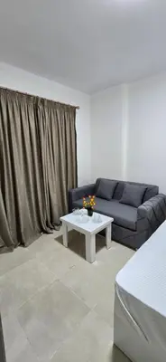 a living room with a couch and a table at Tiba Golden Private Beach Hurghada in Hurghada