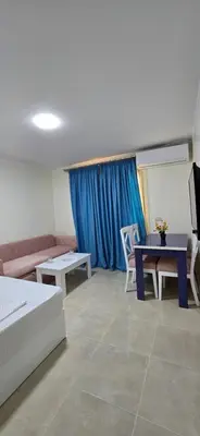 a living room with a couch and a table at Tiba Golden Blue Oasis Hurghada in Hurghada