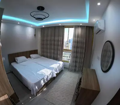 a bedroom with a bed with a blue ceiling at Alhambara compound in Hurghada