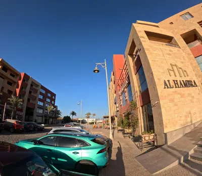 a green car parked in front of a building at Alhambara compound in Hurghada
