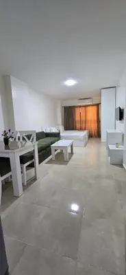 a living room with couches and tables and a couch at Tiba Golden Crystal Water Hurghada in Hurghada