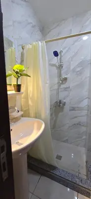 a bathroom with a shower and a sink and a toilet at Tiba Golden Blue Coral Hurghada in Hurghada
