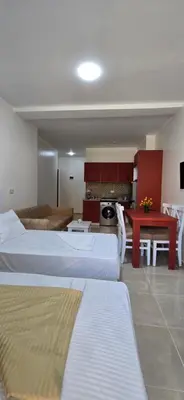 a hotel room with two beds and a kitchen at Tiba Golden Crystal Oasis Hurghada in Hurghada