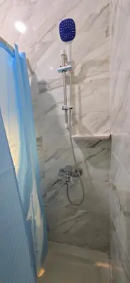 a shower with a shower head in a bathroom at Tiba Golden Golden Coast Hurghada in Hurghada