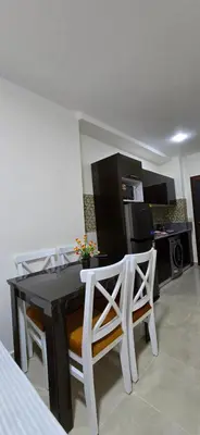 a dining room with a table and two chairs at Tiba Golden Golden Coast Hurghada in Hurghada