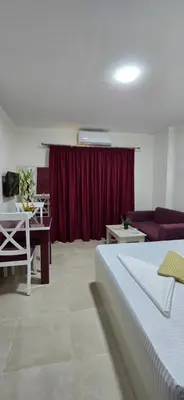 a bedroom with a bed and a red curtain at Tiba Golden Sea Harmony Hurghada in Hurghada