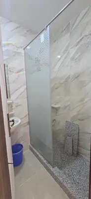 a shower with a glass door in a bathroom at Tiba Golden Serenity Hurghada in Hurghada
