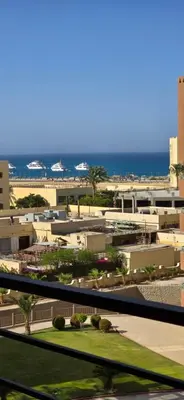 a view of a city with the ocean in the background at Tiba Golden Sun and Sea Hurghada in Hurghada