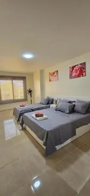 a bedroom with two beds in a room at Tiba Golden Sand Palace Hurghada in Hurghada