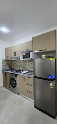 a kitchen with a stainless steel refrigerator and a stove at Tiba Golden Amber Sands Hurghada in Hurghada