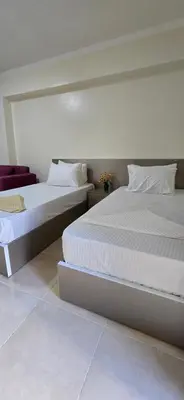 two beds sitting next to each other in a bedroom at Tiba Golden Blue Mirage Hurghada in Hurghada