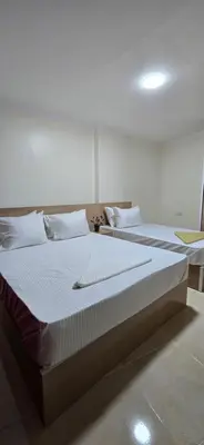 two beds with white sheets and pillows in a room at Tiba Golden Sea Beiss Hurghada in Hurghada