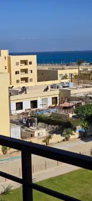 a view from the balcony of a resort with the ocean at Tiba Golden Palm Hurghada in Hurghada