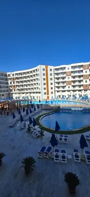 a resort with chairs and umbrellas and a swimming pool at Tiba Golden Azure Coast Hurghada in Hurghada