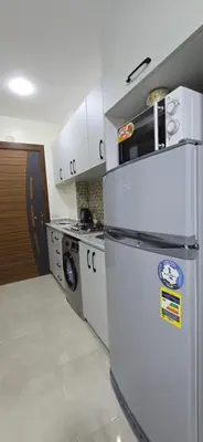 a kitchen with a refrigerator and a washing machine at Tiba Golden Sapphire Hurghada in Hurghada