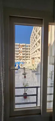 a window with a view of a courtyard outside a building at Tiba Golden Sunset Oasis Hurghada in Hurghada
