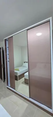 a sliding glass door in a room with a bedroom at Tiba Golden Beach View Hurghada in Hurghada
