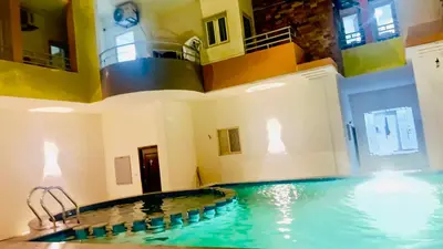 a large swimming pool in a house with a large at Golden Home Hurghada El Kauser in Hurghada
