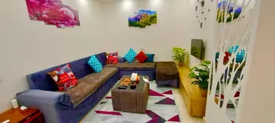 a living room with a couch and a table at Golden Home Hurghada El Kauser in Hurghada