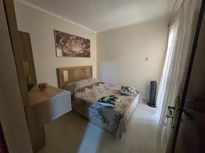 a bedroom with a bed and a dresser in it at شقة in Hurghada