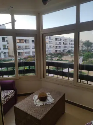 a room with three windows and a table with a donut on it at Summer land in Hurghada