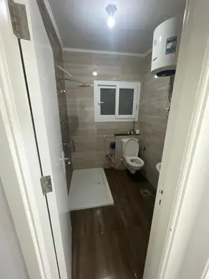 a small bathroom with a toilet and a sink at El Hambra compound in Hurghada