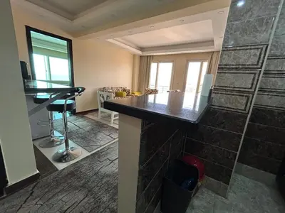 a room with a counter and a stone wall at Sea view chalet in Sahl Hasheesh
