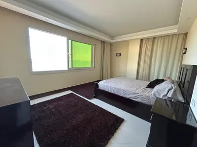 a bedroom with a bed and a large window at Sea view chalet in Sahl Hasheesh
