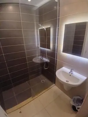 a bathroom with a shower and a sink at Cozy Studio in Hurghada