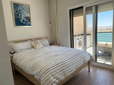 a bedroom with a bed with a view of the ocean at Gouna's Best Villa in Hurghada