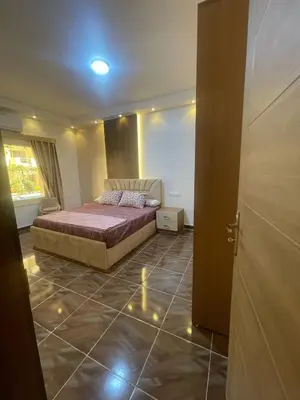 a bedroom with a bed and a couch in a room at apartment for rent in hurghada in Hurghada