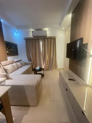 a bedroom with a bed and a couch and a television at apartment for rent in hurghada in Hurghada