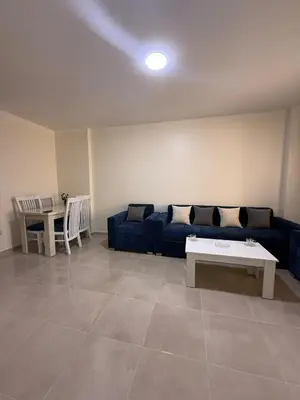 a living room with a blue couch and a table at TiBa Golden Resort in Hurghada