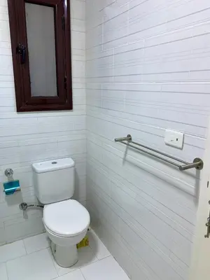 a white bathroom with a toilet and a mirror at Turtles Beach Resort - Hurghada in Hurghada