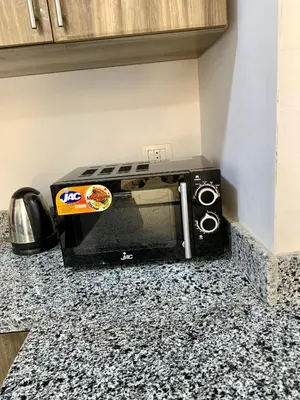 a microwave oven sitting on a counter in a kitchen at Turtles Beach Resort - Hurghada in Hurghada