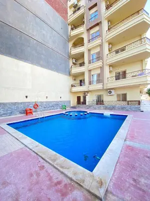 a large swimming pool in front of a building at الغردفه كازبلانكا ريزورت in Hurghada
